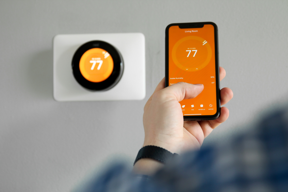 Man,uses,a,mobile,phone,with,smart,home,app,in